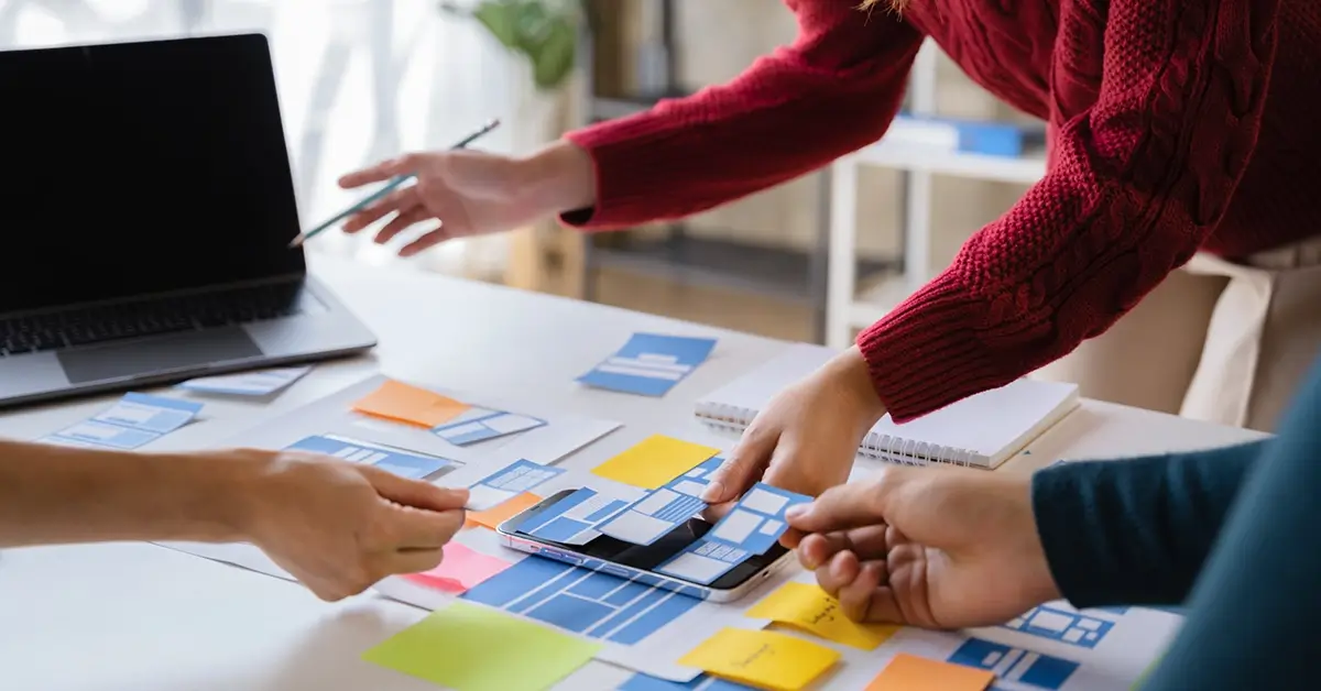 wordpress designer reviewing wireframes for design with her team