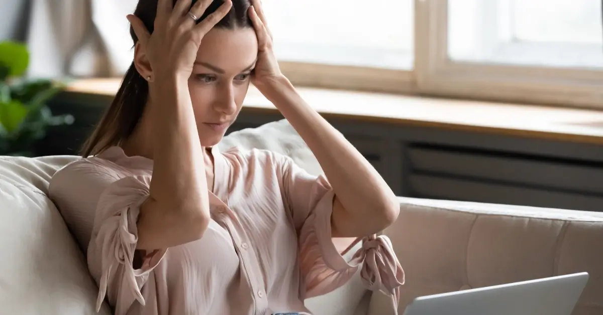 Woman exasperated with her website - the real cost of cheap web hosting