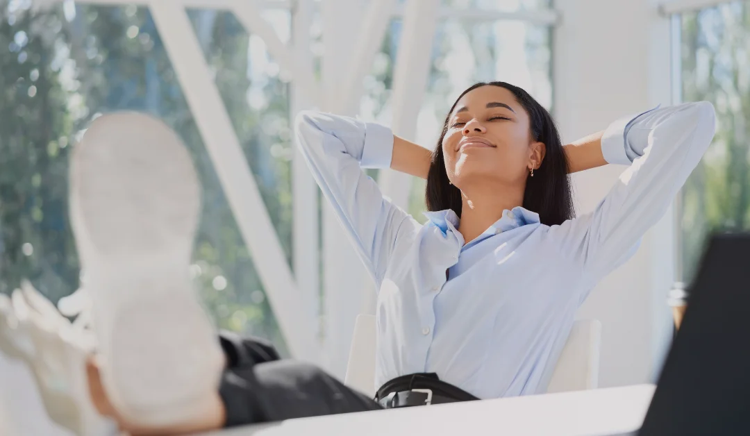 Carefree business woman relaxing at her desk