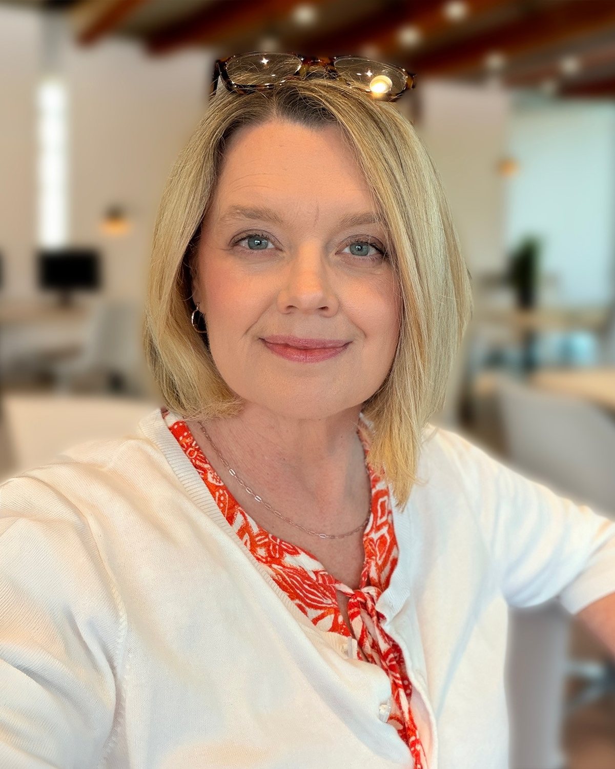 Jeane Sumner, founder and CEO of Website HQ, smiling in her office